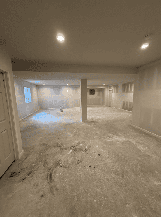 Finished basement living area with recessed lighting and custom built-ins