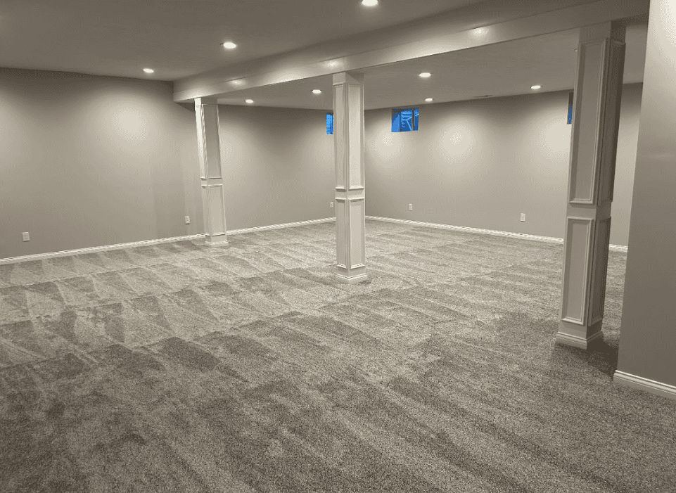 Completed basement living area with seating and built-in storage