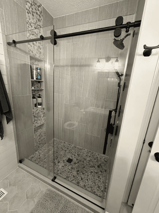 Finished bathroom with tiled shower and modern fixtures