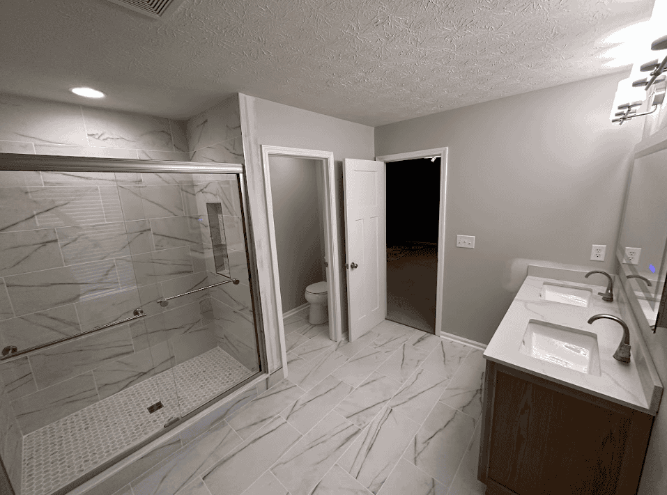 Walk-in tiled shower with glass screen